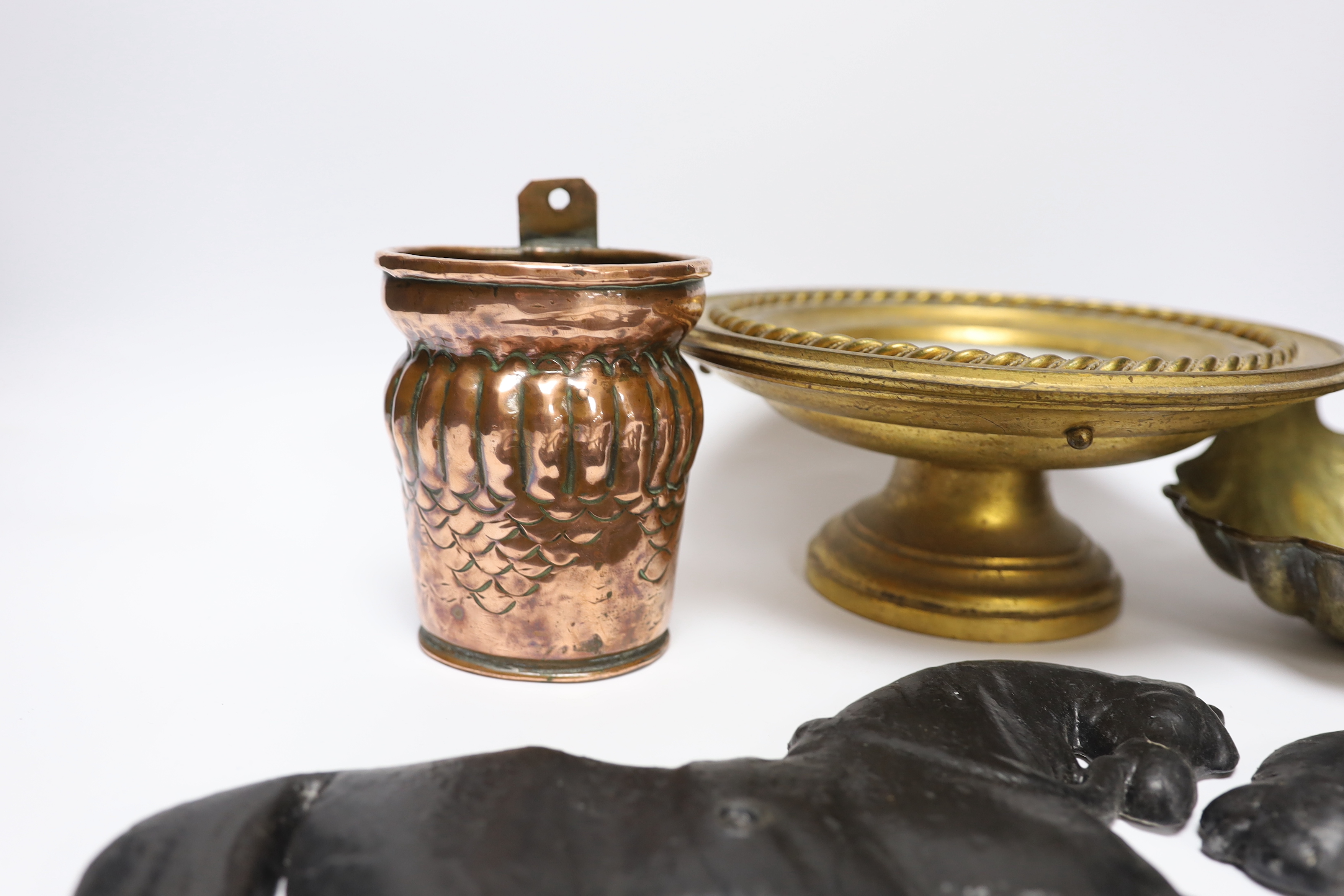 A group of metalware to include a pair of lead ‘horse’ wall mounts, a copper wall pocket, a, brass ‘scallop shell’ dish, a telescopic three pronged fork and an alabaster pedestal dish